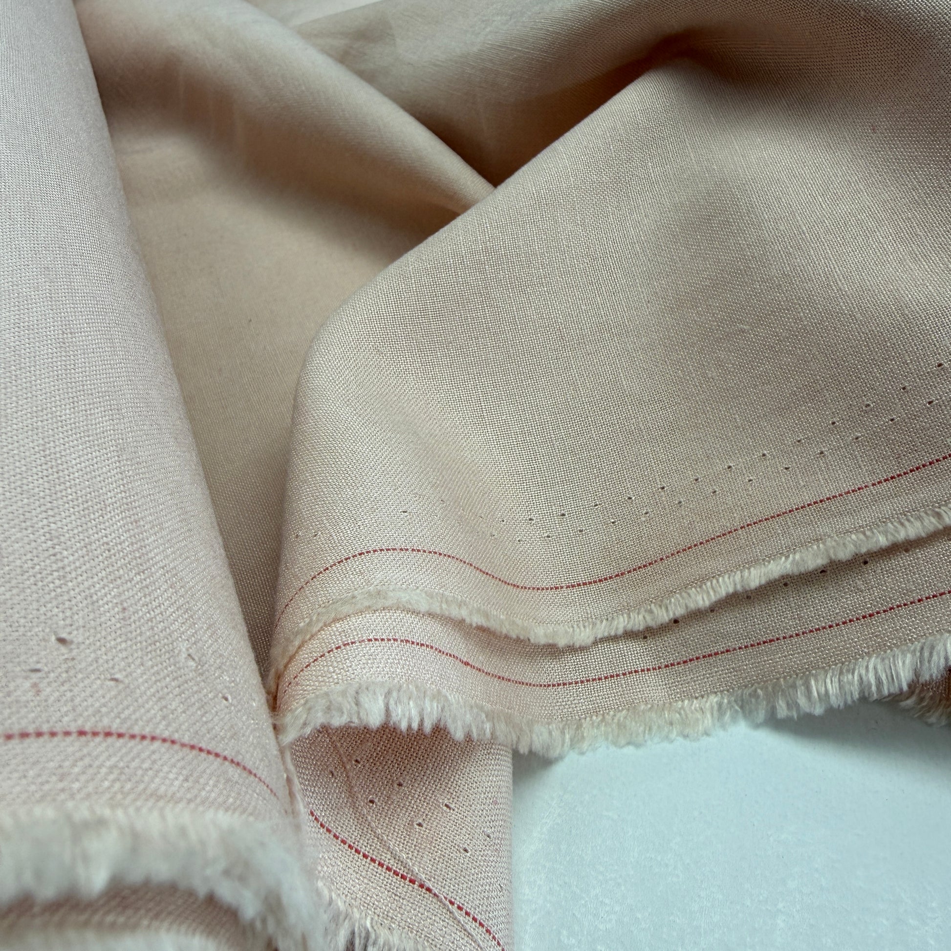 Linen + Viscose + Cotton Mix fabric in light coral pink, showcasing a beautiful drape and texture ideal for summer apparel and home decor.